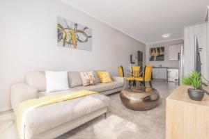 a living room with a couch and a table at Zoe Lodge in Midrand
