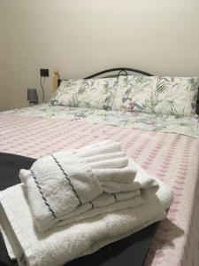 a bed with white towels on top of it at Casa Vacanze Mannara in Scilla +32 photos