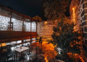 a restaurant with tables and chairs and a brick wall at Kremlin 1908 Hotel in Kars
