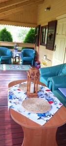 a living room with a table and blue furniture at TLdomki in Radęcin