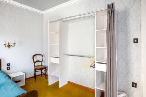 a bedroom with a bed and a chair and a closet at Gîte du forgeron - 6 à 8 personnes - Centre Alsace - Saint-Hippolyte in Saint-Hippolyte +32 photos