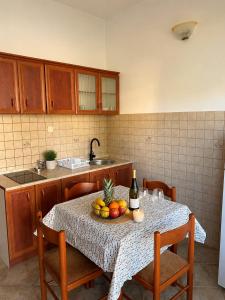 a kitchen with a table with a bowl of fruit on it at Apartment Stegic 1 in Radovici