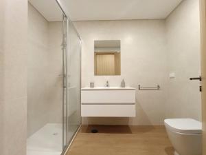 a bathroom with a sink and a toilet at Entrecubos Apartamentos in Olhão +40 photos