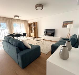 a living room with a couch and a table at Entrecubos Apartamentos in Olhão