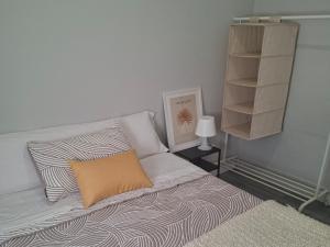 a bedroom with a bed with a pillow and a shelf at Apartamento playa sada in Sada