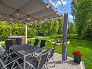 a patio with a table and chairs under a tent at Lake House Szteklin in Szteklin