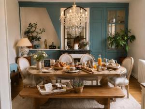 a dining room with a table with food on it at Chez Mary in Larzicourt