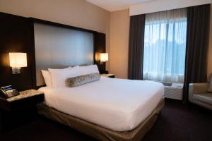 a hotel room with a large bed and a window at Win-River Resort and Casino in Redding +29 photos