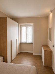 a bedroom with a bed and a window at La Terrazza, comfort e relax tra i laghi in Borgomanero