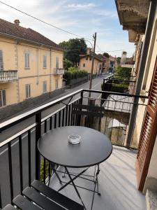 a table on a balcony with a view of a street at La Terrazza, comfort e relax tra i laghi in Borgomanero