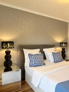 a bedroom with two beds with blue and white pillows at Casa do Piquinho in Ponta do Sol +20 photos