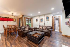 a living room with leather furniture and a table at Wild Irishman #1030 in Keystone