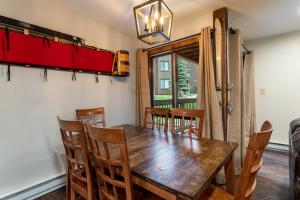 a dining room with a wooden table and chairs at Wild Irishman #1030 in Keystone +33 photos