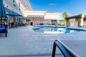 a swimming pool at a hotel with tables and chairs at Win-River Resort and Casino in Redding