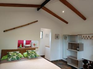 a bedroom with a large bed and a bathroom at Baliyana Lodge in San José Pinilla +16 photos
