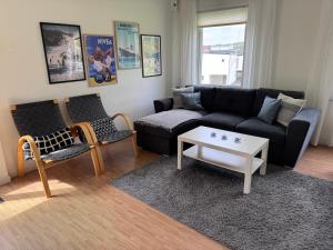 a living room with a couch and a coffee table at Hällestrand Vandrarhem - Lägenhet "Laxen" in Strömstad