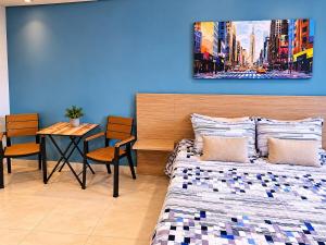 a bedroom with a bed and a table with chairs at Laureles Premium Loft con Jacuzzi Privado in Medellín