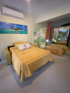 a bedroom with a large bed and a large window at Le loft Acajou in Le Lamentin