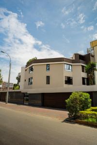 a large white building with a garage at Hostal Los Cactus in Lima