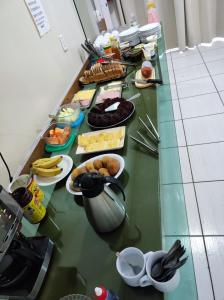 a counter top with food on it in a kitchen at Hotel Jacaré in Ituporanga