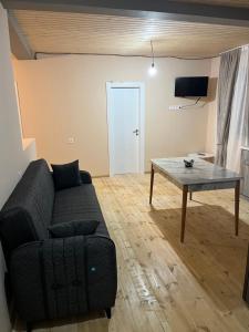 a living room with a couch and a table at Leo Guesthouse in Dolasvip'i