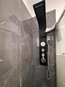 a hair dryer is hanging on a wall in a bathroom at Vanity Suite in Cefalù +110 photos