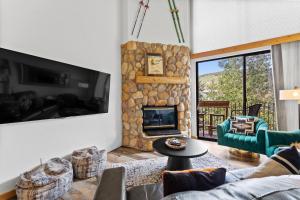 a living room with a couch and a fireplace at Summit House East #313 in Copper Mountain