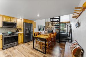 a kitchen with a table and a dining room at Summit House East #313 in Copper Mountain