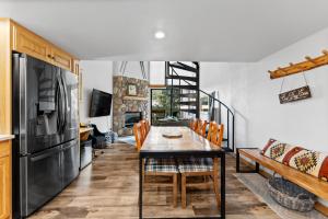 a kitchen and dining room with a table and a refrigerator at Summit House East #313 in Copper Mountain +22 photos