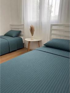a bedroom with two beds and a table at De Papel Villa in Jankoviči +33 photos