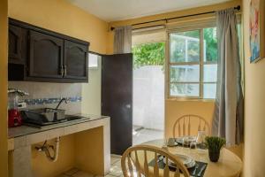 a kitchen with a table and a sink and a window at Estudio #1 a 10 min del malecon in La Paz