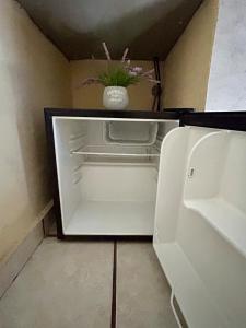 a white refrigerator with a vase with a plant in it at Estudio #1 a 10 min del malecon in La Paz +18 photos