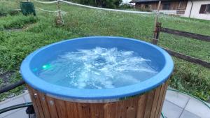 a bucket of water in a wooden barrel at Gruppenhaus Braz in Innerbraz