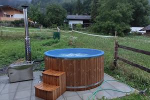 a hot tub in the middle of a yard at Gruppenhaus Braz in Innerbraz