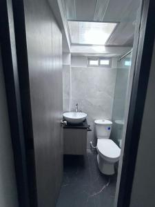 a bathroom with a toilet and a sink at Park Suite in Ibagué +3 photos