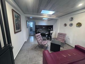 a living room with a couch and chairs and a table at Park Suite in Ibagué