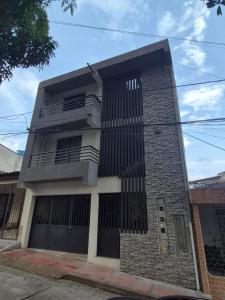 a tall brick building with black doors and windows at Park Suite in Ibagué