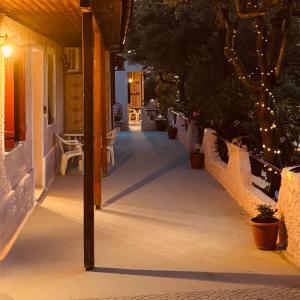 a walkway leading to a house at night at Gradakia Cottages 2 in Argostoli