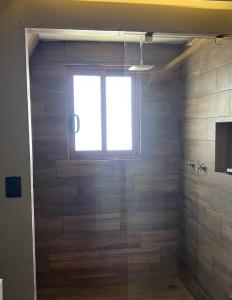 a bathroom with a glass shower with a window at Estancia las Jacarandas Cabañas in San Gabriel Etla +14 photos