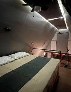 a bedroom with a bed and a ceiling fan at Estancia las Jacarandas Cabañas in San Gabriel Etla