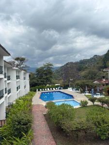 a view of a swimming pool next to a building at Hotel Turístico de Tenza in Tenza