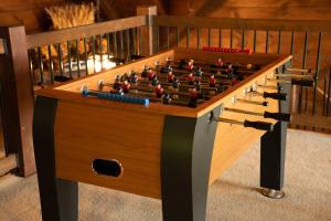 a foosball table with a chessboard on it at Cucumber Tree Lodge in Banner Elk