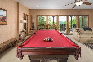 a pool table in a living room with at Cucumber Tree Lodge in Banner Elk