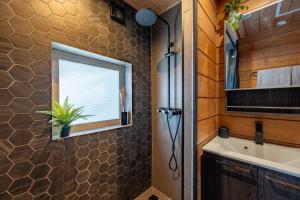 a bathroom with a sink and a window at Hooting Owl private ski chalet in Niseko +45 photos