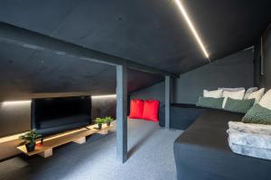a living room with a flat screen tv and a couch at Hooting Owl private ski chalet in Niseko