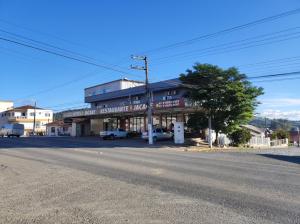 a building on the side of a street with a road at Hotel Jacaré in Ituporanga