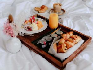 a tray with two plates of food on a bed at Pullman Sydney Penrith in Penrith