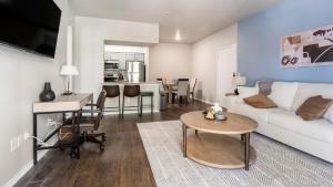 a living room with a white couch and a table at Landing Spectacular 1BD Pool Gym in San Antonio