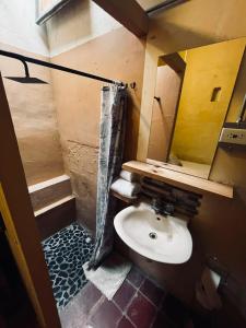 a small bathroom with a sink and a mirror at Coliving Granada in Envigado