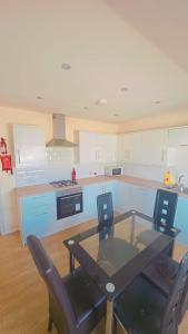a kitchen with a glass table and chairs in it at studio with ensuite in New Bedfont